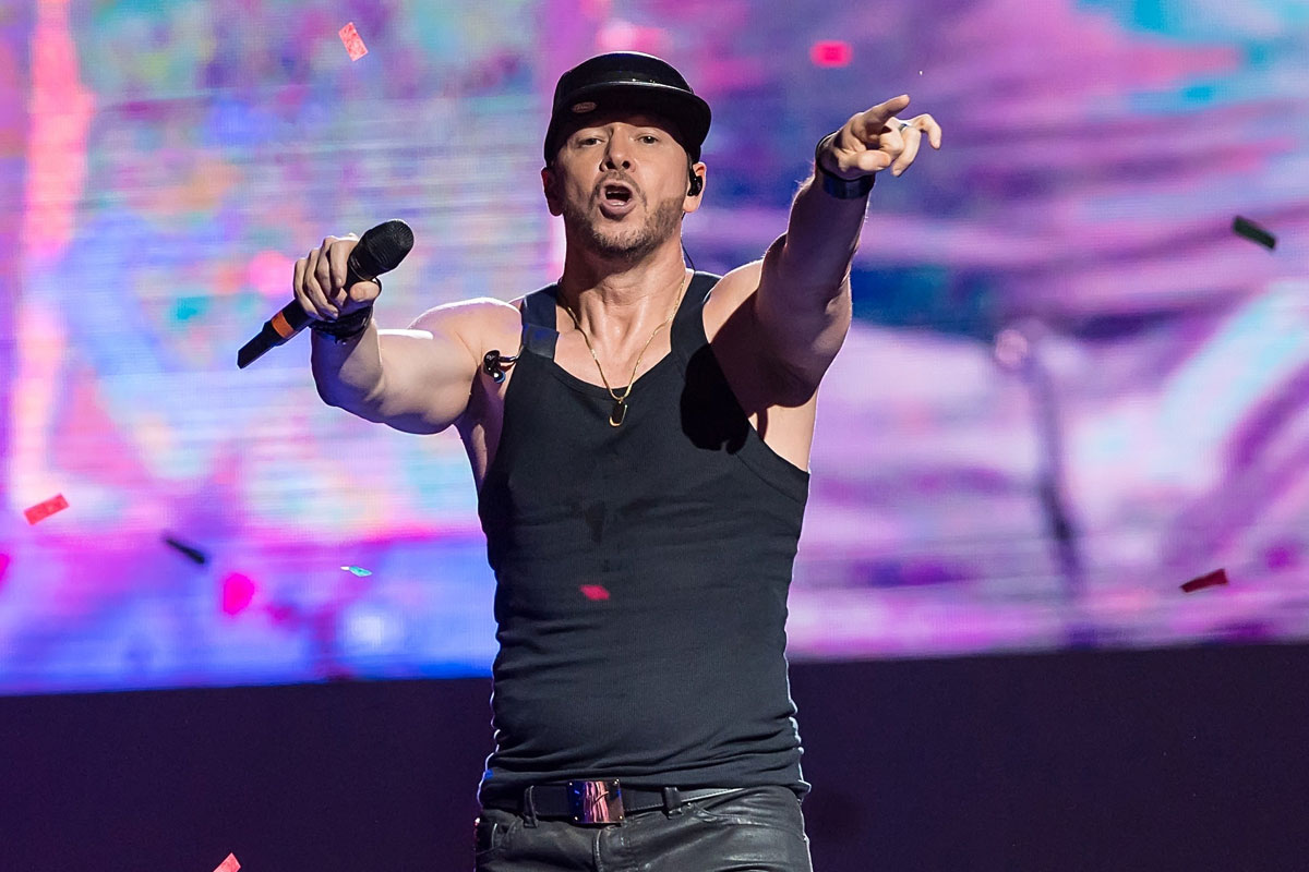 Elijah Hendrix Wahlberg performing on stage with Pink Laces band during live music concert