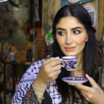 Linda Furrha holding traditional cup showcasing her lifestyle as social media influencer discussing Linda Furrha net worth 2025