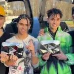 obre Brothers Net Worth - Four brothers Lucas, Marcus, Cyrus and Darius holding YouTube play buttons by luxury car