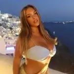 Alanna Pow net worth featured image showing Australian influencer in Santorini Greece for lifestyle content