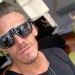 Chris Diamond wearing sunglasses and chain necklace showing his lifestyle reflecting his net worth