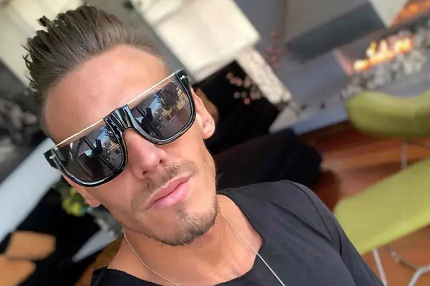 Chris Diamond wearing sunglasses and chain necklace showing his lifestyle reflecting his net worth