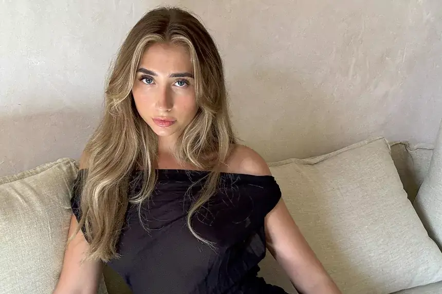 Lily Phillips net worth overview showing the OnlyFans content creator in casual setting discussing her financial success