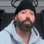 Mike Stud net worth rapper performing on stage with microphone