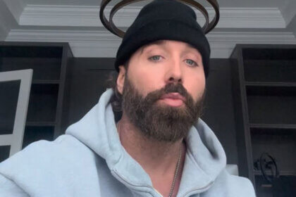 Mike Stud net worth rapper performing on stage with microphone