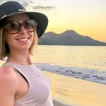 Serenity Cox smiling at beach sunset, representing her successful career and growing net worth in 2025