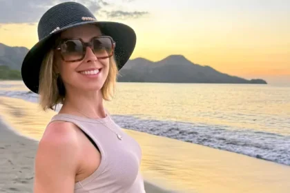 Serenity Cox smiling at beach sunset, representing her successful career and growing net worth in 2025