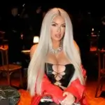 Laci Kay Somers at a public event wearing a black outfit and red jacket, related to Laci Kay Somers net worth 2026