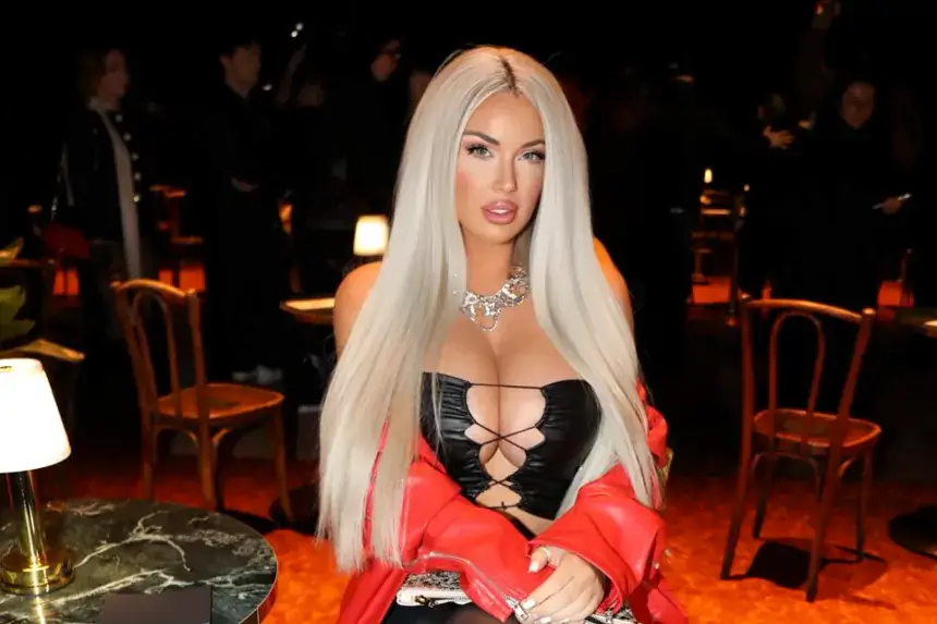 Laci Kay Somers at a public event wearing a black outfit and red jacket, related to Laci Kay Somers net worth 2026