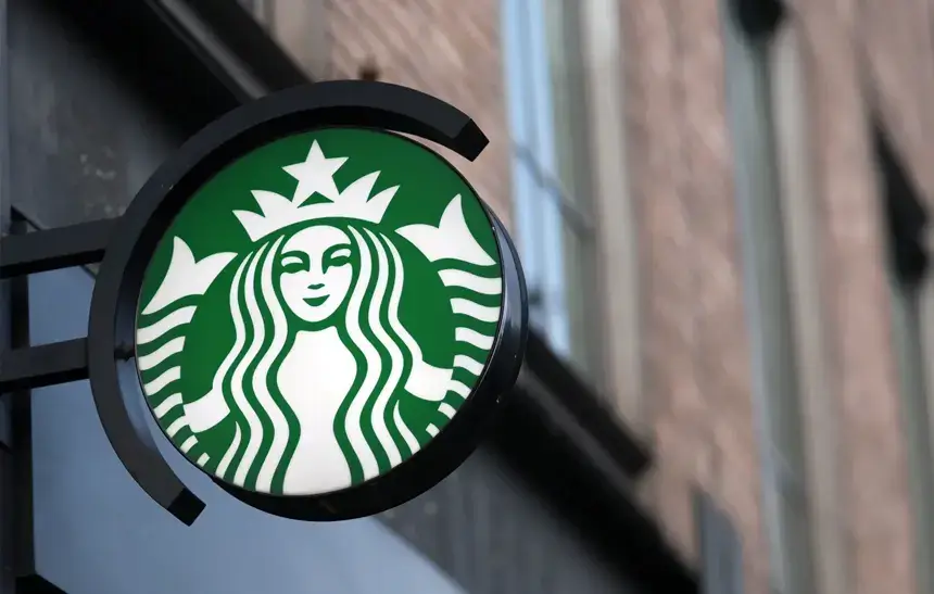 Starbucks logo sign on a brick wall representing the Starbucks Dumfries Closure in January 2025