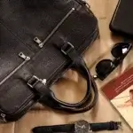 Leather briefcase and accessories showing signs of wear for leather repair shop in Brandywine Valley