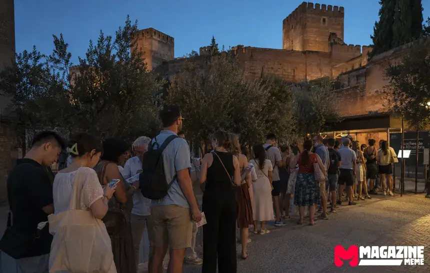 Tourists waiting outside the Alhambra entrance before a summer night tour in Granada