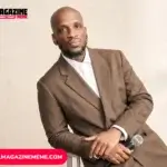 Ali Siddiq net worth profile - Houston stand-up comedian seated in brown suit holding microphone