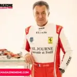 Jean Alesi in a Ferrari-branded HRX racing suit standing beside a scale model Formula 1 car