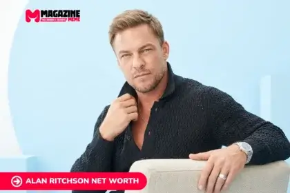 Alan Ritchson net worth profile photo in dark textured cardigan, seated portrait