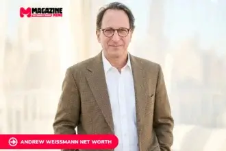 Andrew Weissmann portrait in brown tweed blazer, smiling indoors near sheer curtains