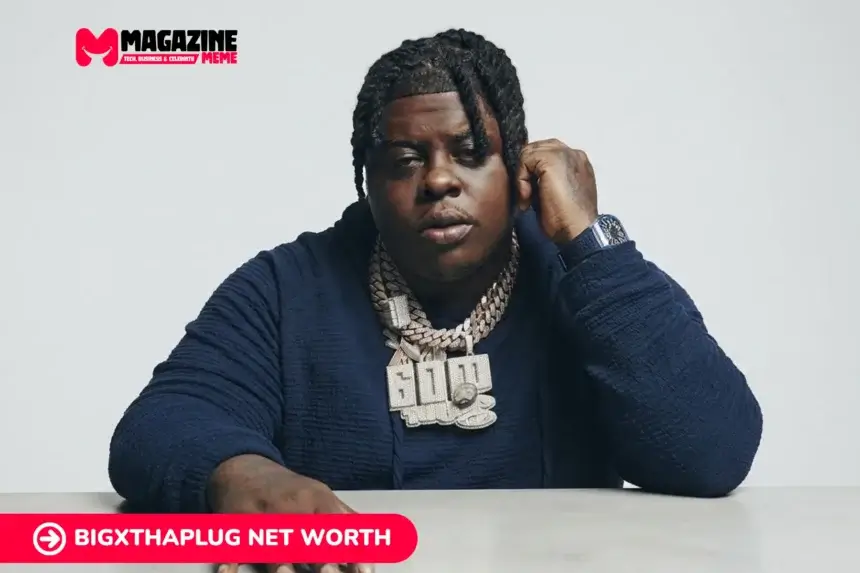 BigXthaPlug wearing a diamond "600" chain and watch, seated at a table