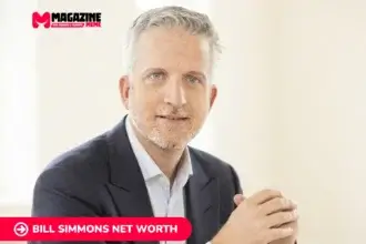Bill Simmons in navy suit, gray hair and beard, hands clasped