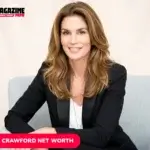 Cindy Crawford smiling in black blazer, seated portrait