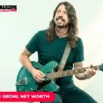Dave Grohl net worth subject playing green guitar seated on stool
