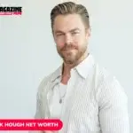 Derek Hough smiling in striped white shirt, studio portrait