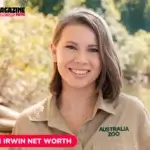 Bindi Irwin smiling outdoors in her Australia Zoo uniform, featured for the Bindi Irwin net worth article.