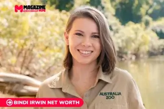 Bindi Irwin smiling outdoors in her Australia Zoo uniform, featured for the Bindi Irwin net worth article.