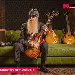 Billy Gibbons seated with a sunburst guitar and vintage amp, featured for the Billy Gibbons net worth article