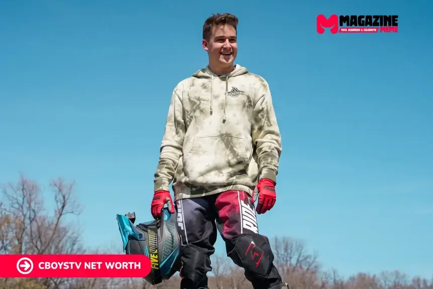 CboysTV photo of a smiling man in a tie-dye hoodie and motocross gear holding a helmet, for the Cboystv net worth article